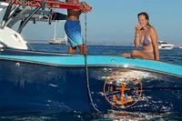 2020 MasterCraft X26 boat with people enjoying a sunny day on the water.