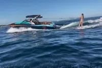 2020 MasterCraft X26 towing a wakeboarder on a sunny day.
