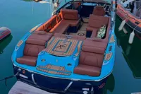 2020 MasterCraft X26 boat with luxurious seating and sleek design, docked on calm water.