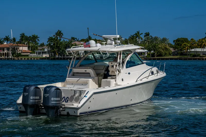  Yacht Photos Pics 2014 Pursuit 345os boat cruising on a sunny day with twin Yamaha engines.