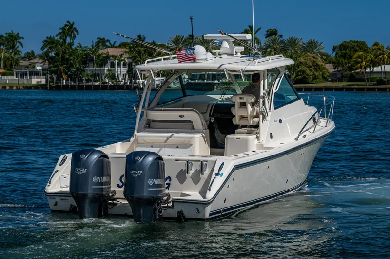  Yacht Photos Pics 2014 Pursuit 345os boat with twin Yamaha engines on a sunny day.