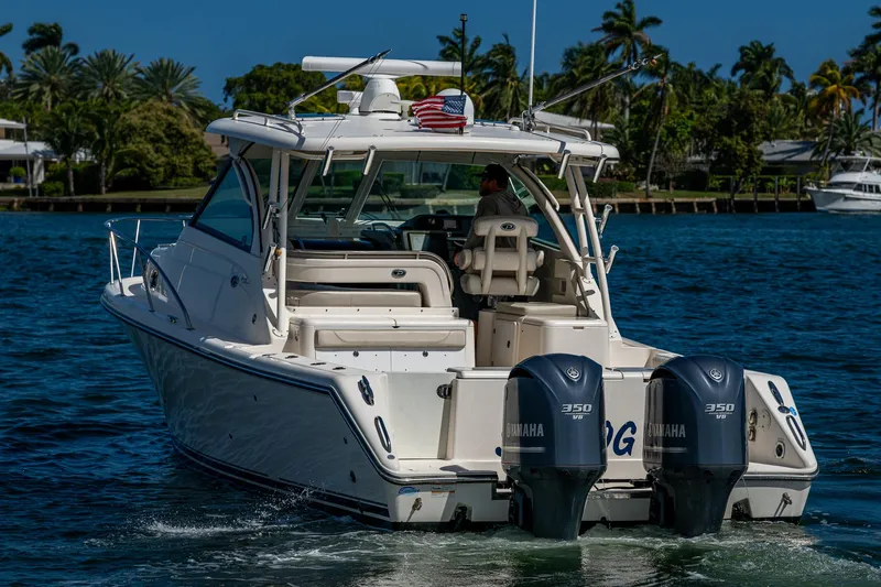  Yacht Photos Pics 2014 Pursuit 345os boat cruising on a sunny day with twin Yamaha engines.