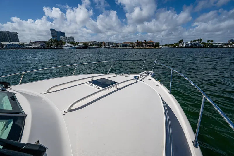  Yacht Photos Pics 2014 Pursuit 345os boat on water with city skyline in background.