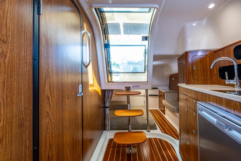  Yacht Photos Pics Interior of 2014 Pursuit 345os boat with wood finishes and modern kitchen amenities.