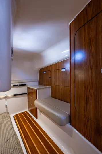 Yacht Photos Pics Interior of 2014 Pursuit 345os boat with wood paneling and seating.