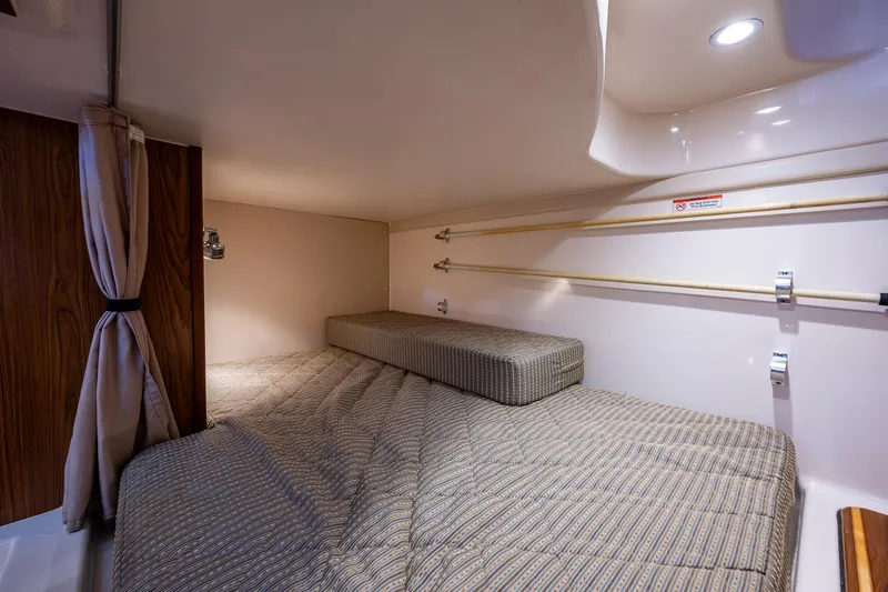  Yacht Photos Pics 2014 Pursuit 345os cabin interior with cozy bed and ambient lighting.