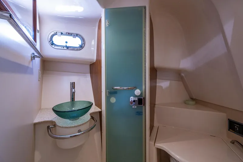  Yacht Photos Pics 2014 Pursuit 345os yacht bathroom with glass sink and frosted door.