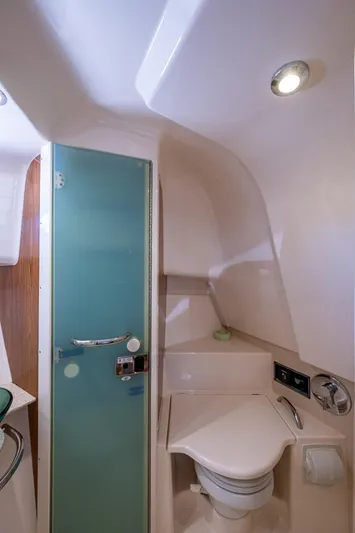  Yacht Photos Pics 2014 Pursuit 345os boat bathroom with modern fixtures and frosted glass door.