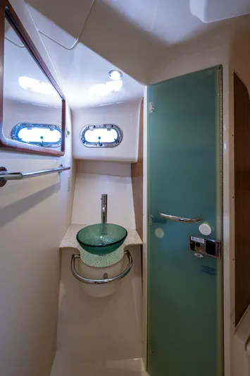  Yacht Photos Pics 2014 Pursuit 345os boat bathroom with glass sink and modern fixtures.