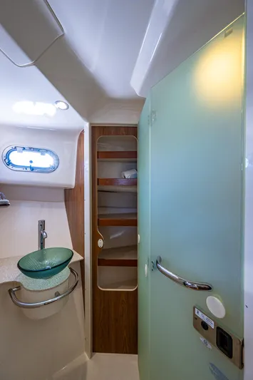  Yacht Photos Pics 2014 Pursuit 345os boat interior bathroom with modern sink and frosted glass door.