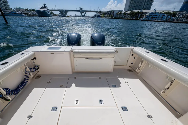  Yacht Photos Pics 2014 Pursuit 345os boat deck with dual engines on a sunny day.