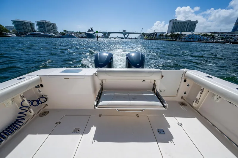  Yacht Photos Pics 2014 Pursuit 345os boat deck with twin engines on a sunny day.
