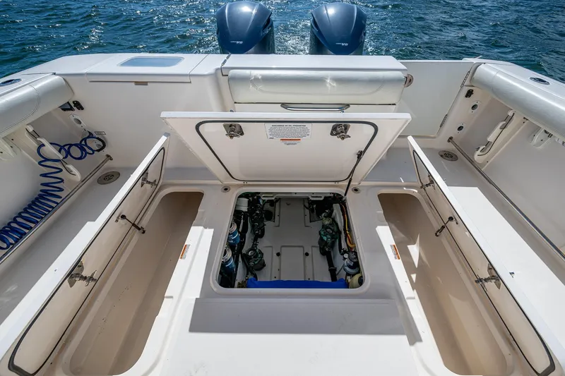  Yacht Photos Pics 2014 Pursuit 345os boat deck with open storage compartments and twin engines.