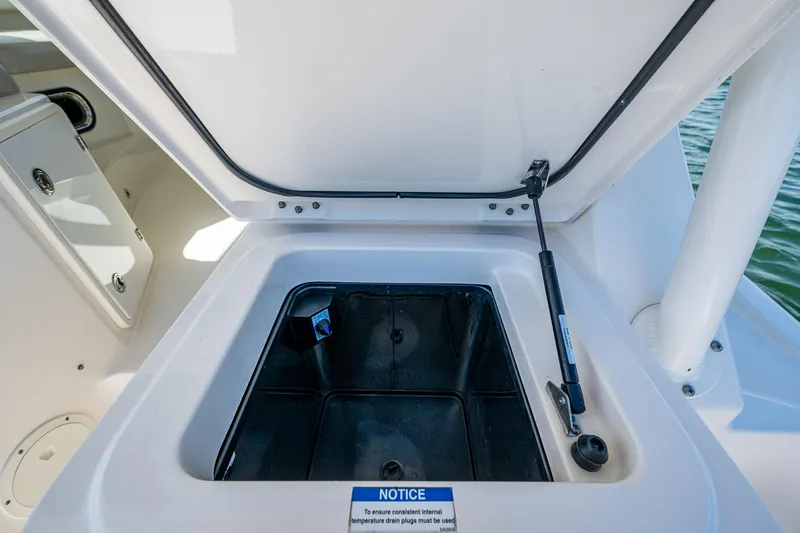  Yacht Photos Pics Open storage compartment on a 2014 Pursuit 345os boat, showing interior details.