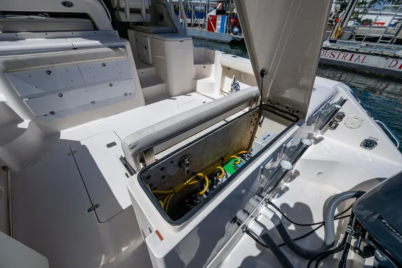  Yacht Photos Pics 2014 Pursuit 345os boat interior with open storage compartment, showcasing seating and equipment.