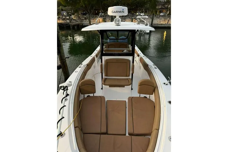  Yacht Photos Pics 2021 Sea Hunt Gamefish 30 with forward seating, docked by the water.