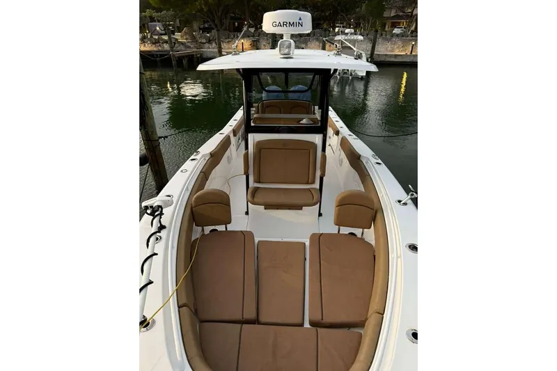  Yacht Photos Pics 2021 Sea Hunt Gamefish 30 Forward Seating boat with tan cushions, docked by the water.