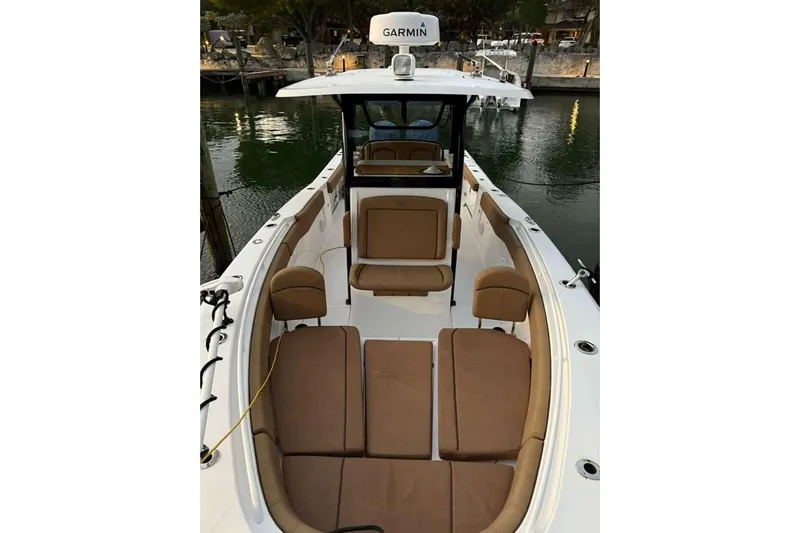  Yacht Photos Pics 2021 Sea Hunt Gamefish 30 Forward Seating boat with brown cushions, docked by the water.