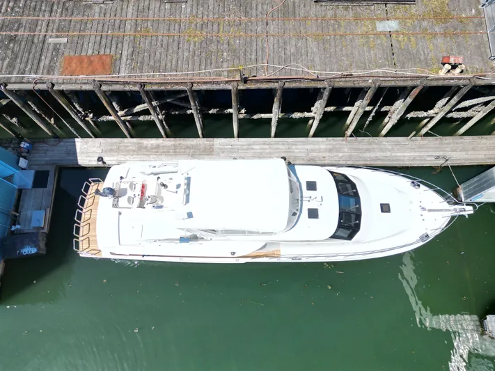 Safari Yacht Photos Pics Aerial view of 2001 Symbol 66 Pilothouse Yacht docked at a wooden pier.