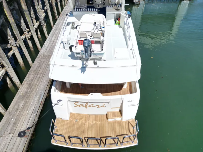 Safari Yacht Photos Pics 2001 Symbol 66 Pilothouse Yacht docked, aerial view of deck and water.