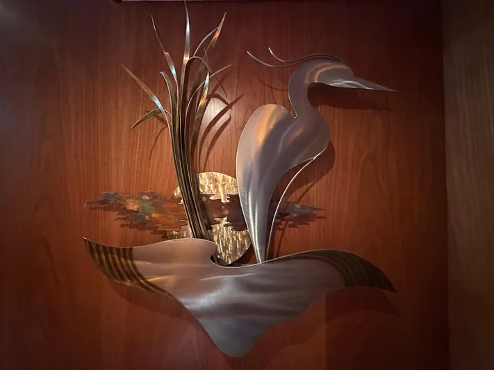 Safari Yacht Photos Pics Metal heron sculpture on wooden wall, Symbol 66 Pilothouse Yacht, 2001.