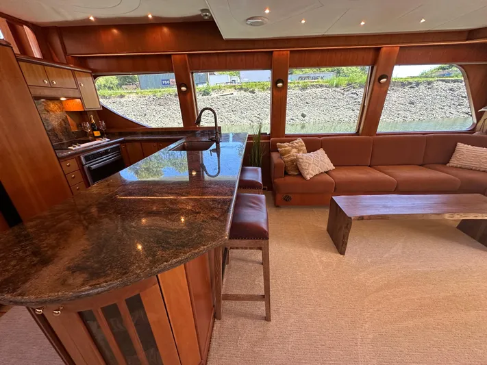 Safari Yacht Photos Pics Luxurious interior of a 2001 Symbol 66 Pilothouse Yacht with elegant wood finishes.