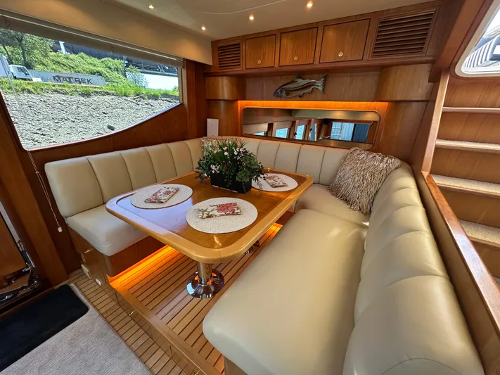 Safari Yacht Photos Pics Luxurious interior of 2001 Symbol 66 Pilothouse Yacht with elegant dining area and plush seating.