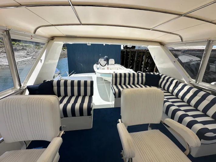 Safari Yacht Photos Pics Luxurious 2001 Symbol 66 Pilothouse Yacht interior with striped seating and elegant design.