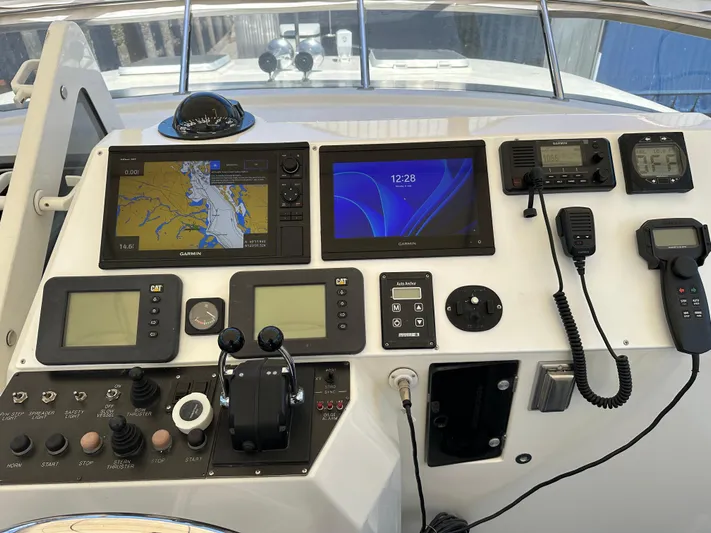 Safari Yacht Photos Pics Control panel of a 2001 Symbol 66 Pilothouse Yacht with navigation and communication equipment.