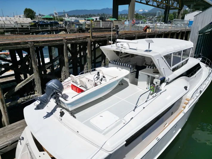 Safari Yacht Photos Pics 2001 Symbol 66 Pilothouse Yacht docked, featuring spacious deck and tender boat.