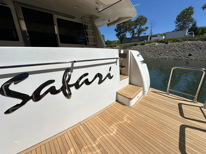 Safari Yacht Photos Pics 2001 Symbol 66 Pilothouse Yacht docked, featuring "Safari" name on deck.