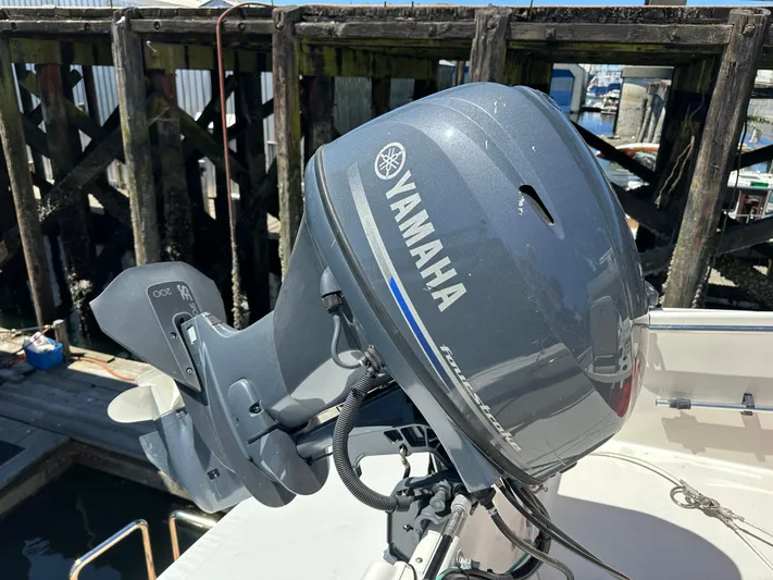Safari Yacht Photos Pics Yamaha outboard motor on 2001 Symbol 66 Pilothouse Yacht, docked near wooden pier.