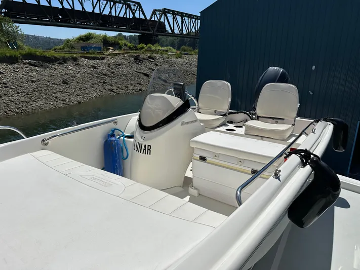 Safari Yacht Photos Pics 2001 Symbol 66 Pilothouse Yacht with seating, docked near a bridge.