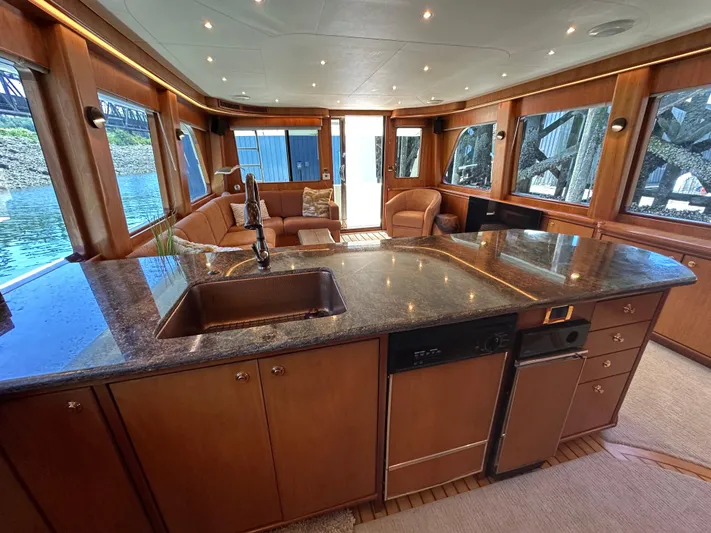 Safari Yacht Photos Pics Luxurious interior of a 2001 Symbol 66 Pilothouse Yacht with elegant wood finishes and modern amenities.