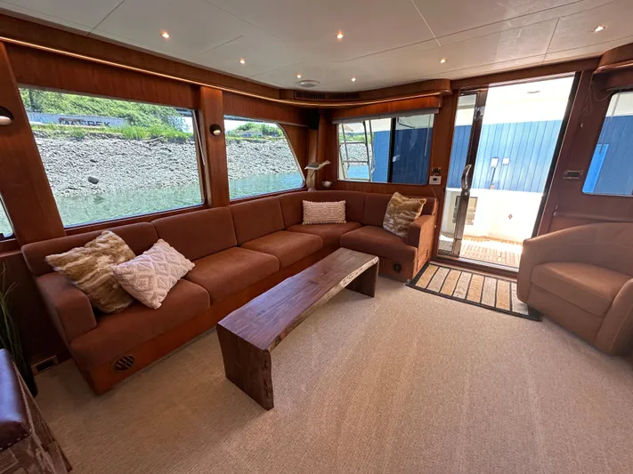 Safari Yacht Photos Pics Luxurious interior of 2001 Symbol 66 Pilothouse Yacht with plush seating and wooden accents.