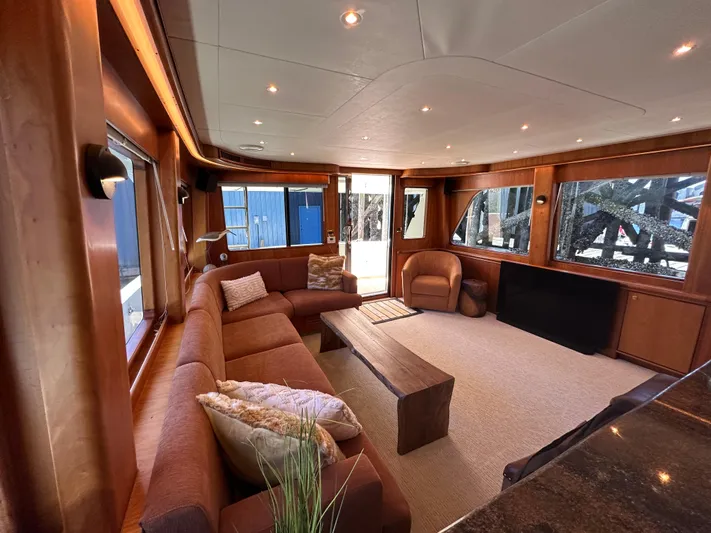 Safari Yacht Photos Pics Luxurious interior of a 2001 Symbol 66 Pilothouse Yacht with elegant seating and wood finishes.