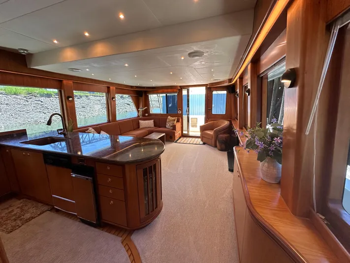 Safari Yacht Photos Pics Luxurious interior of 2001 Symbol 66 Pilothouse Yacht with elegant wood finishes and modern amenities.