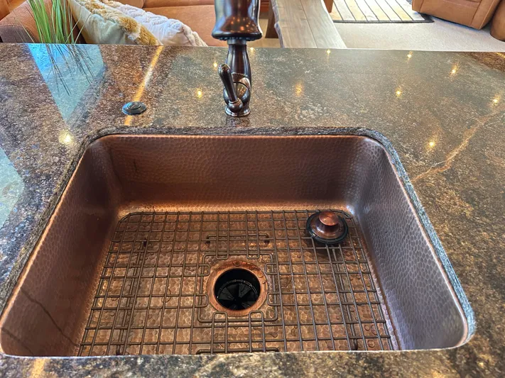 Safari Yacht Photos Pics Luxurious kitchen sink on 2001 Symbol 66 Pilothouse Yacht with granite countertop.