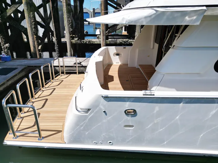 Safari Yacht Photos Pics 2001 Symbol 66 Pilothouse Yacht docked, featuring spacious deck and sleek design.