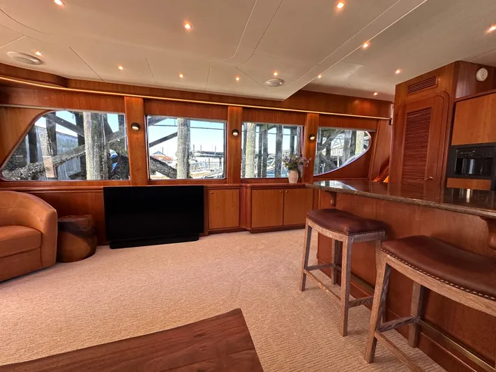 Safari Yacht Photos Pics Luxurious interior of a 2001 Symbol 66 Pilothouse Yacht with elegant wood finishes.