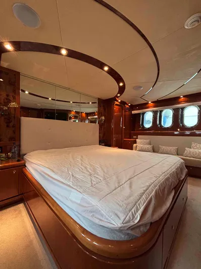  Yacht Photos Pics Luxurious bedroom interior of 2005 Monte Fino 82 yacht with elegant wood finishes.