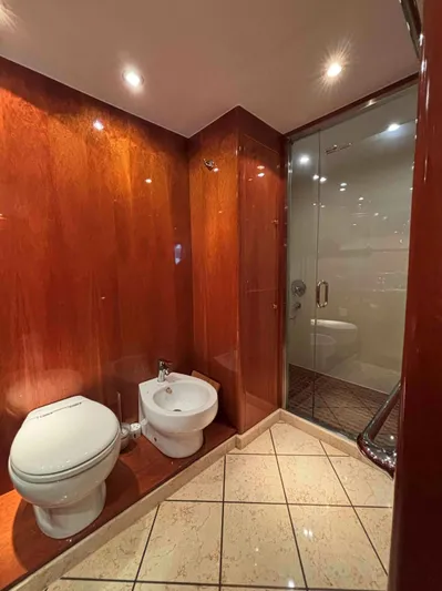  Yacht Photos Pics Luxurious bathroom on 2005 Monte Fino 82 yacht with wood paneling and glass shower.