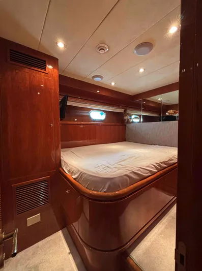  Yacht Photos Pics Luxurious cabin interior of 2005 Monte Fino 82 yacht with wood paneling and cozy bed.