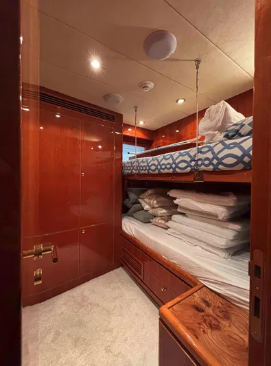  Yacht Photos Pics Luxurious cabin interior of 2005 Monte Fino 82 yacht with wooden finishes and bunk beds.