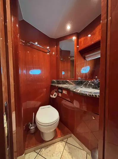  Yacht Photos Pics Luxurious bathroom in 2005 Monte Fino 82 yacht with wood paneling and marble countertop.