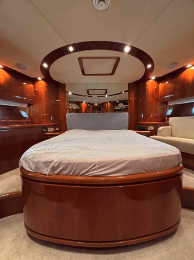  Yacht Photos Pics Luxurious bedroom interior of 2005 Monte Fino 82 yacht with elegant wood finishes.