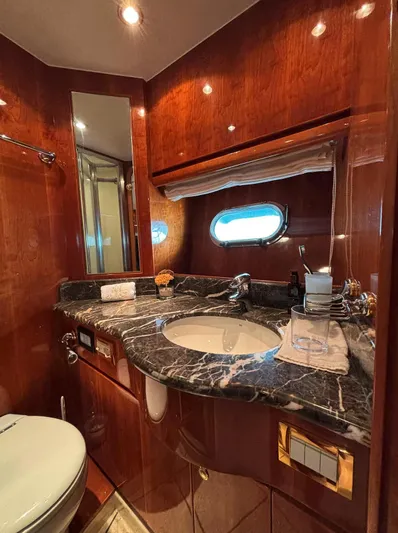  Yacht Photos Pics Luxurious bathroom in 2005 Monte Fino 82 yacht with marble countertop and wooden finishes.
