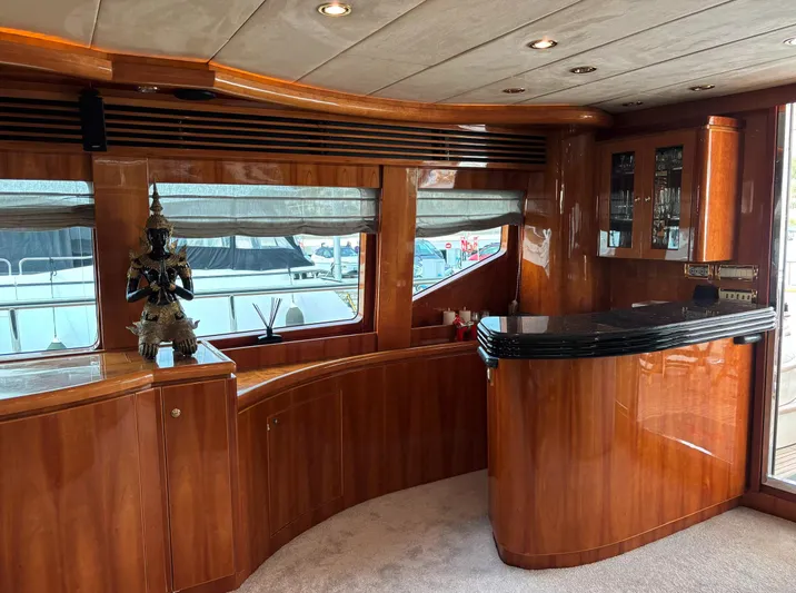  Yacht Photos Pics Luxurious interior of 2005 Monte Fino 82 yacht with polished wood and elegant decor.