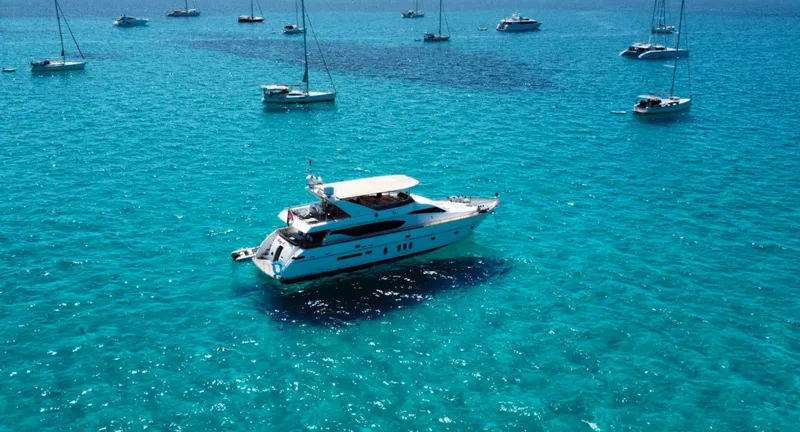  Yacht Photos Pics Luxury Monte Fino 82 yacht from 2005 on clear turquoise waters, surrounded by sailboats.