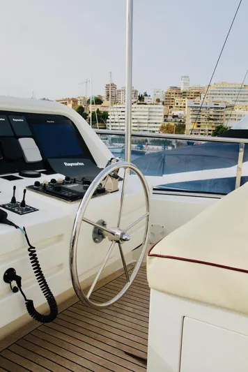  Yacht Photos Pics Steering wheel of a 2005 Monte Fino 82 yacht with cityscape background.